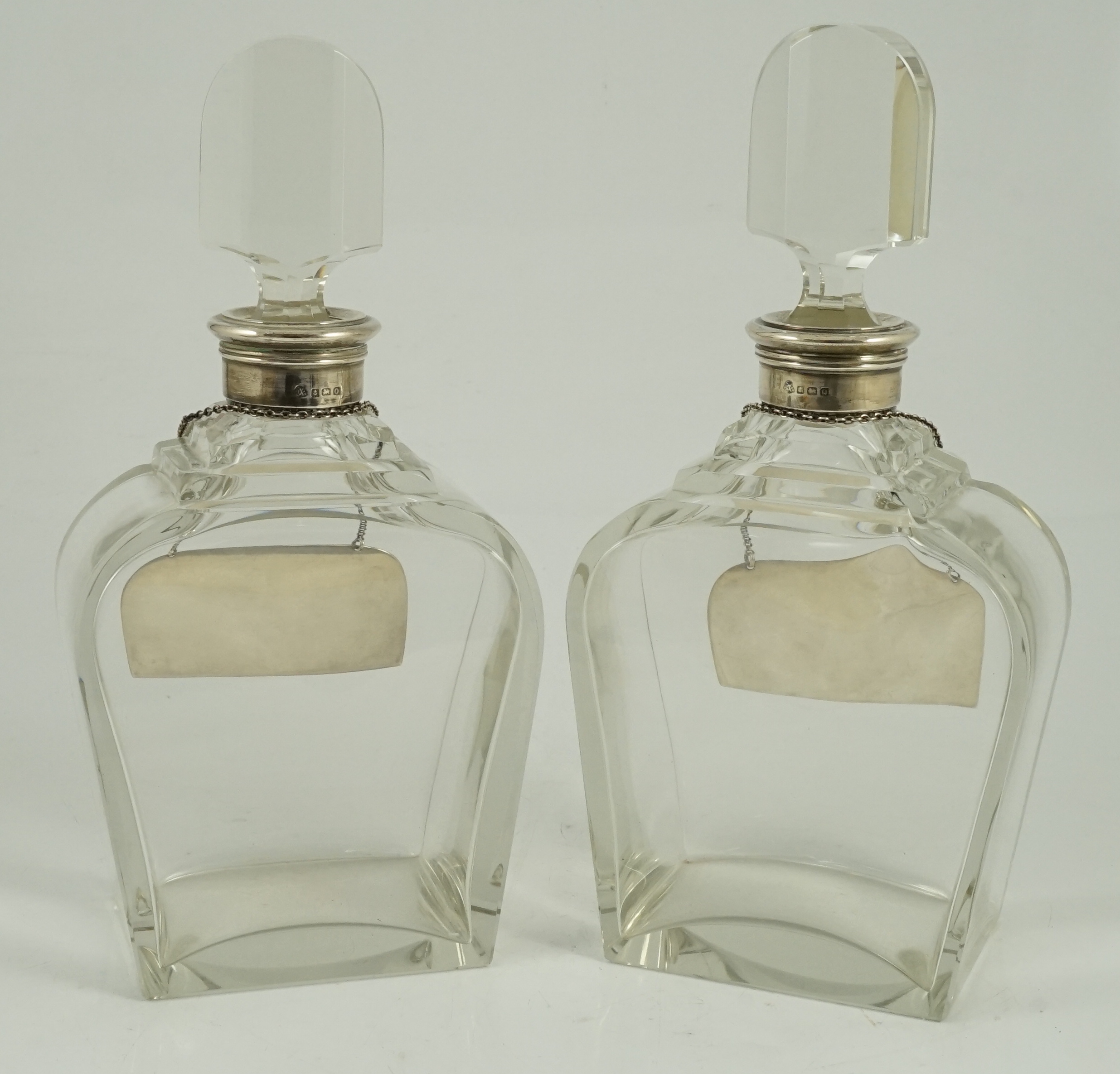 A pair of George VI silver mounted glass decanters and stoppers, by Adie Bros, presented to Mr. J.M. Gordon, to celebrate fifty five years with the D'Oyly Carte Opera Company